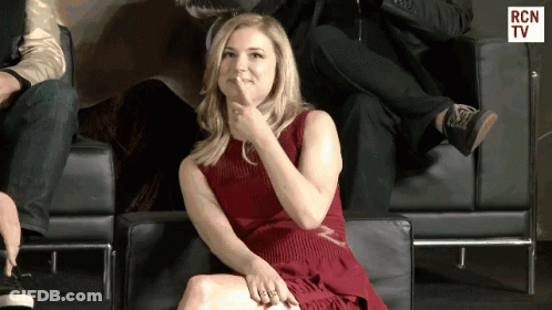 Woman In Red Dress Sitting In Chair With RCN TV GIF