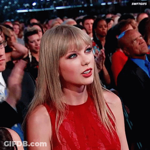 Woman In Red Dress Sitting In Crowd Swiftgifs GIF