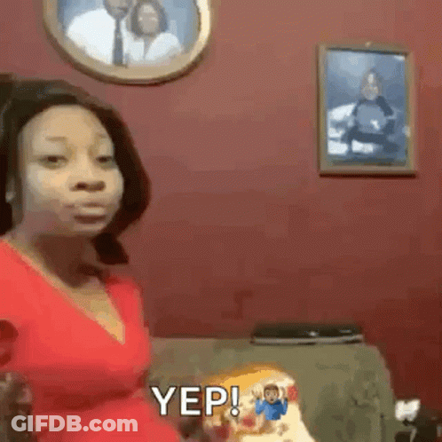 Woman In Red Dress Sitting On Couch GIF