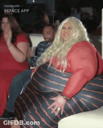 Woman In Red Dress Sitting On Couch With Reface App Text GIF