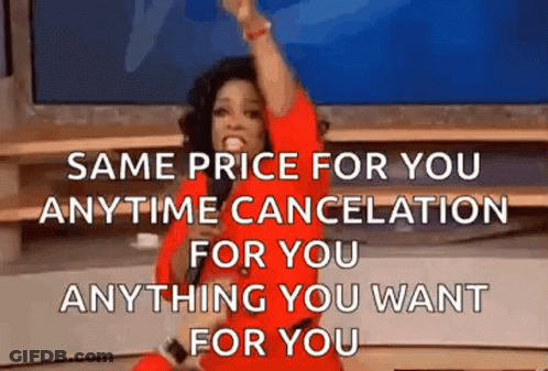 Woman In Red Dress Sitting On Stage With Arm Up GIF