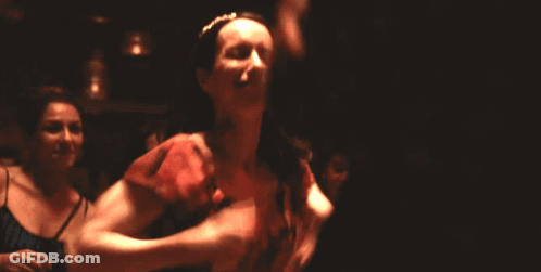 Woman In Red Dress Smiling And Dancing GIF