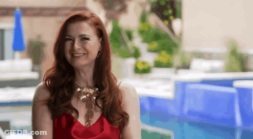Woman In Red Dress Smiling By Swimming Pool GIF