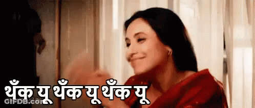 Woman In Red Dress Smiling By Window With Foreign Language Sign GIF
