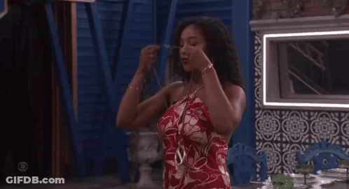 Woman In Red Dress Standing At Table GIF