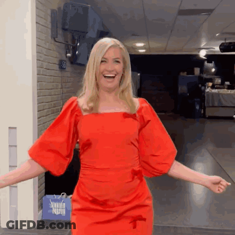 Woman In Red Dress Standing By Sewing Supply Bag GIF
