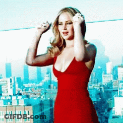 Woman In Red Dress Standing In Front Of City GIF