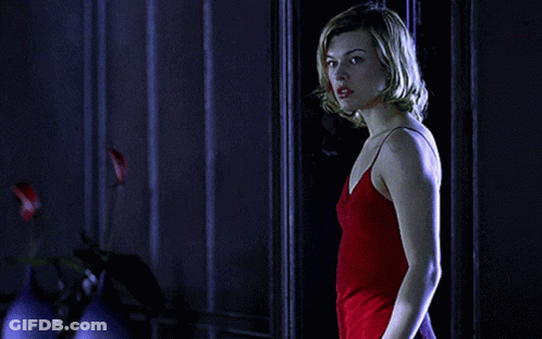 Woman In Red Dress Standing In Front Of Door GIF