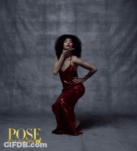 Woman In Red Dress Standing In Front Of Pose Wall GIF