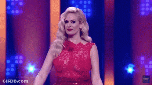 Woman In Red Dress Standing In Front Of Stage GIF