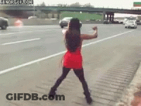 Woman In Red Dress Standing On Highway GIF