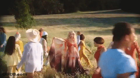 Woman In Red Dress Surrounded By People GIF