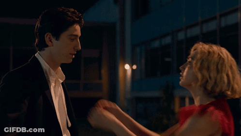 Woman In Red Dress Touching Man In Suit GIF