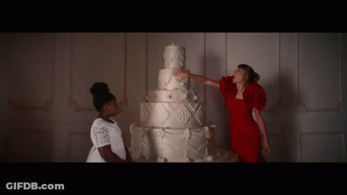 Woman In Red Dress Touching White Cake GIF