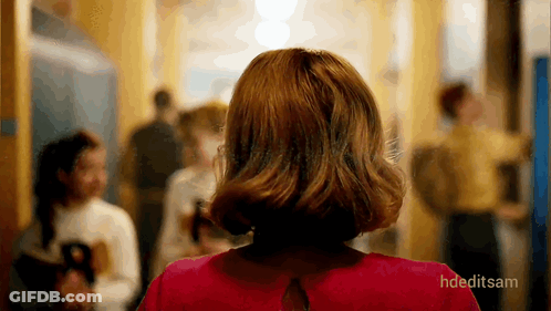 Woman In Red Dress Walking Down Hallway GIF