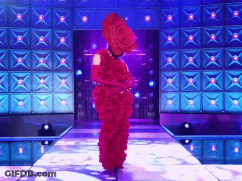Woman In Red Dress Walking Down Stage GIF