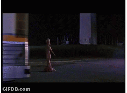 Woman In Red Dress Walking Down Street GIF