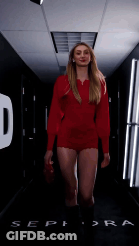 Woman In Red Dress Walking Past Sephora Sign GIF