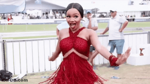 Woman In Red Dress With Arms Outstretched GIF