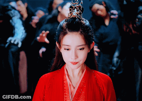 Woman In Red Dress With Crown In Front Of Crowd GIF
