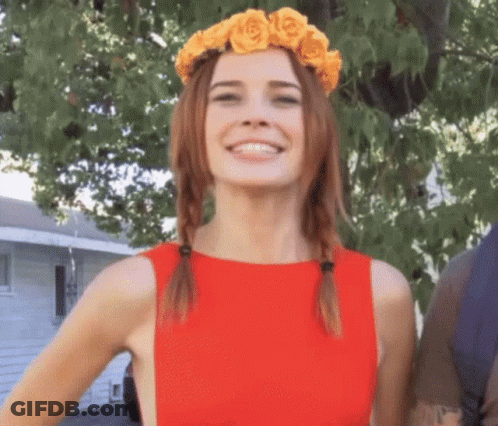 Woman In Red Dress With Yellow Rose Wreath Smiling GIF