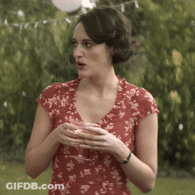 Woman In Red Floral Dress Holding Wine GIF