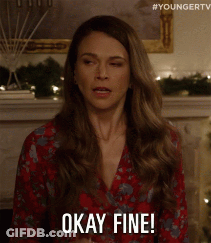 Woman In Red Floral Dress Holding Wine Says Okay Fine GIF