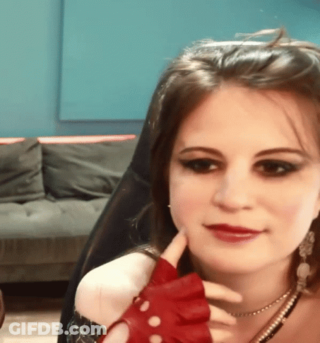 Woman In Red Gloves Sitting With Chin On Hand GIF