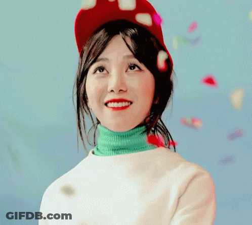 Woman In Red Hat And Green Turtleneck Smiling GIF