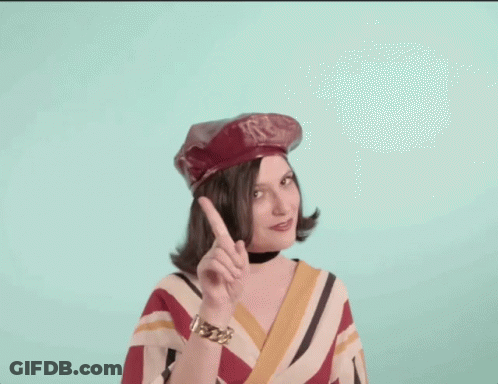 Woman In Red Hat And Striped Shirt Pointing Up GIF