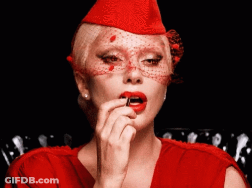 Woman In Red Hat Applying Lipstick GIF