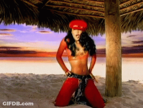 Woman In Red Hat Kneeling On Beach GIF