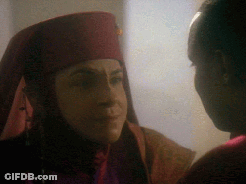 Woman In Red Hat Looking At Another Woman GIF