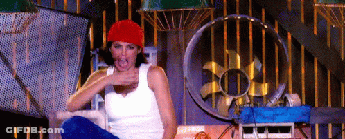 Woman In Red Hat Sitting In Room With Fan GIF