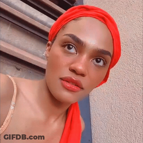 Woman In Red Head Scarf Looking Sideways GIF