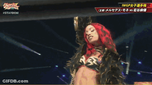 Woman In Red Head Scarf Next To Woman In Gold Outfit Stardom GIF