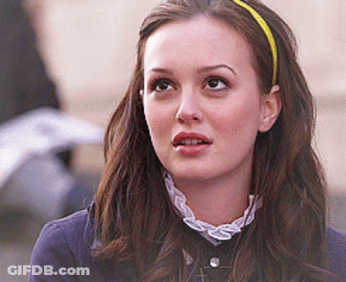 Woman In Red Headband Talking To Another GIF
