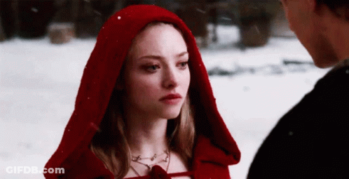 Woman In Red Hooded Cape Looking At Man In Snow GIF