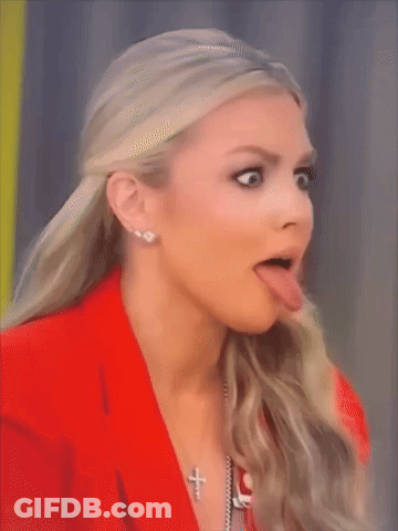 Woman In Red Jacket And Cross Necklace Sticking Tongue Out GIF