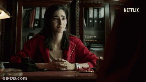 Woman In Red Jacket At Desk GIF
