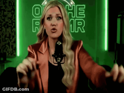 Woman In Red Jacket At Microphone GIF