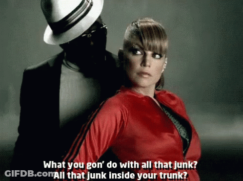 Woman In Red Jacket Beside Man In Black Suit And Hat GIF