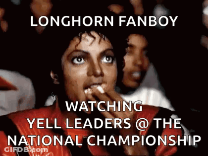 Woman In Red Jacket Eating Popcorn Watching Yell Leaders At National Championship GIF