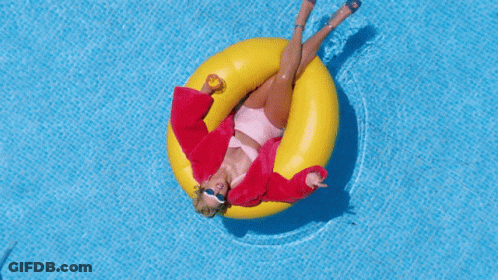 Woman In Red Jacket Floating On Yellow Raft GIF