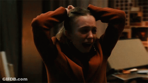 Woman In Red Jacket Holding Head In Hands GIF
