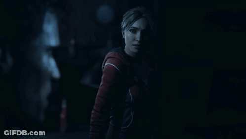 Woman In Red Jacket In Dark Room GIF