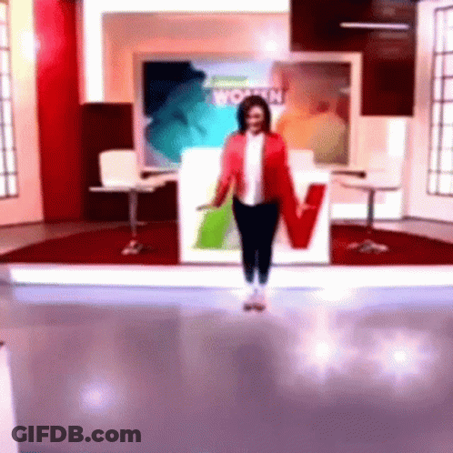 Woman In Red Jacket In Front Of Women Sign GIF