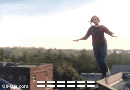 Woman In Red Jacket Jumping Off Ledge With CC GIF