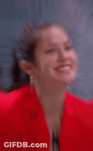 Woman In Red Jacket Making Heart GIF