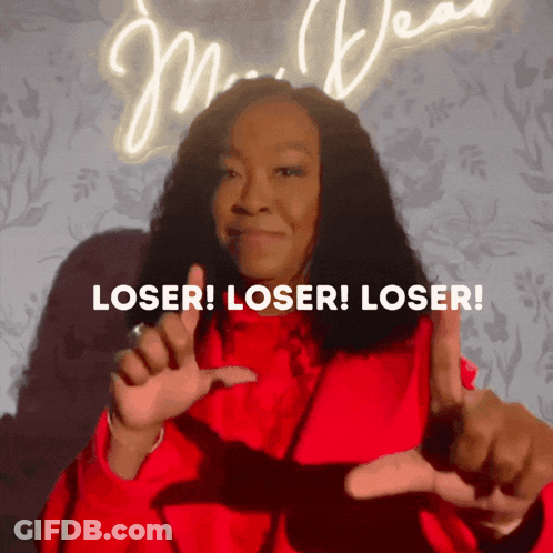 Woman In Red Jacket Making Loser Sign GIF